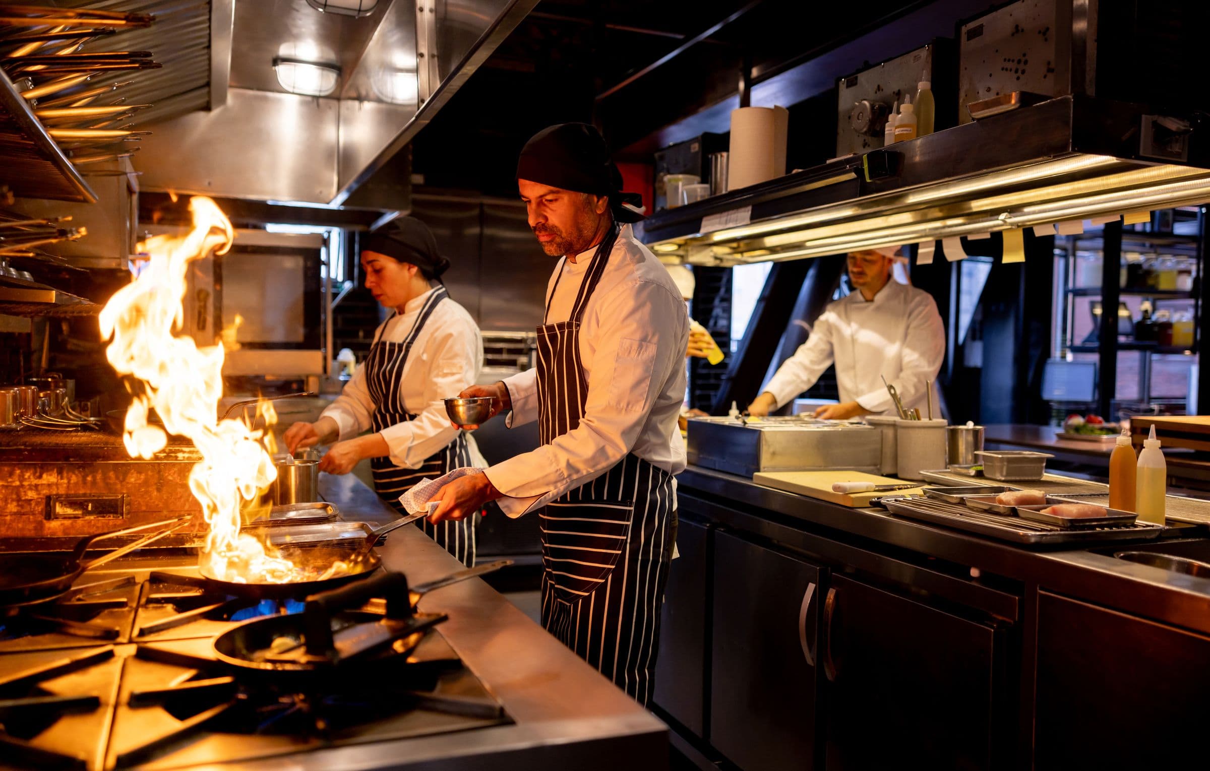 Chef cooking on a commercial kitchen line