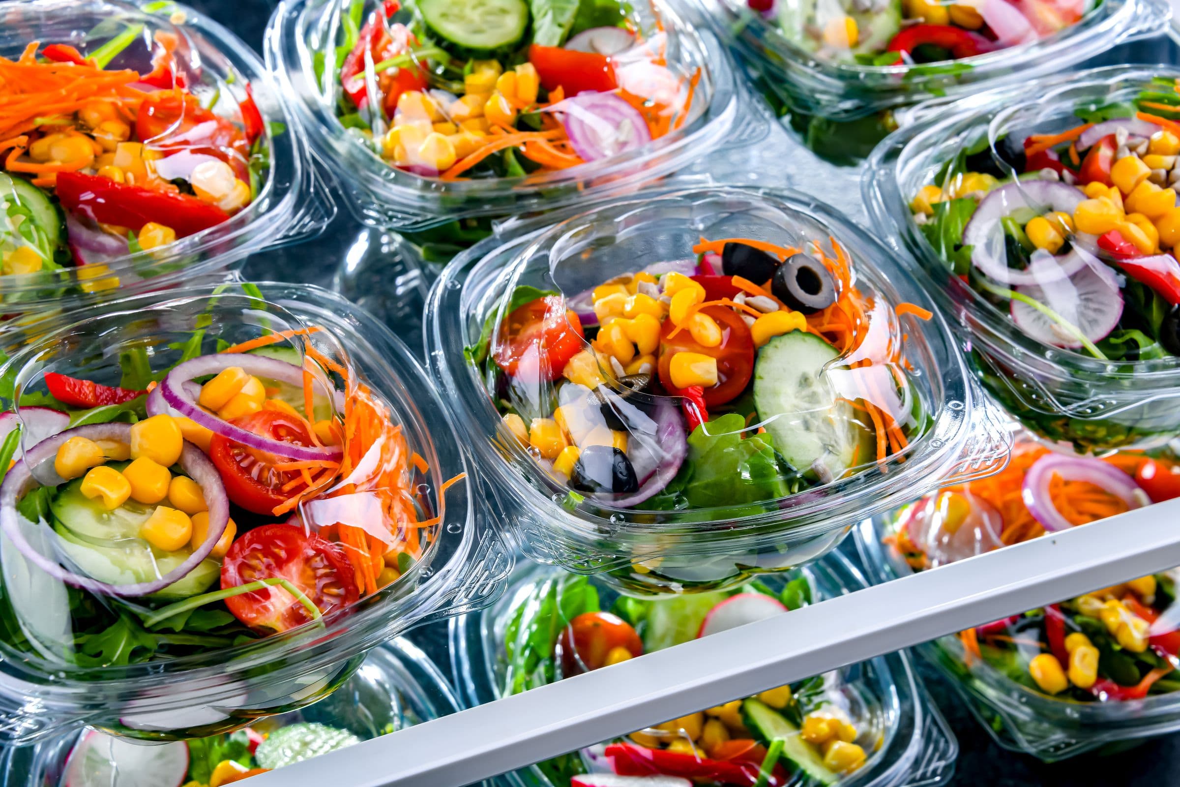 Fresh grab-and-go salads in clear takeout containers